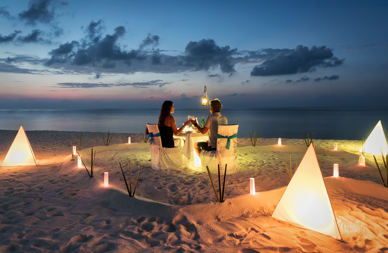 Honeymoon couple is having a private, romantic dinner