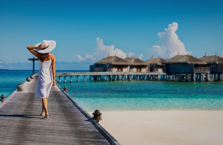 Woman in white walking over a wooden jetty